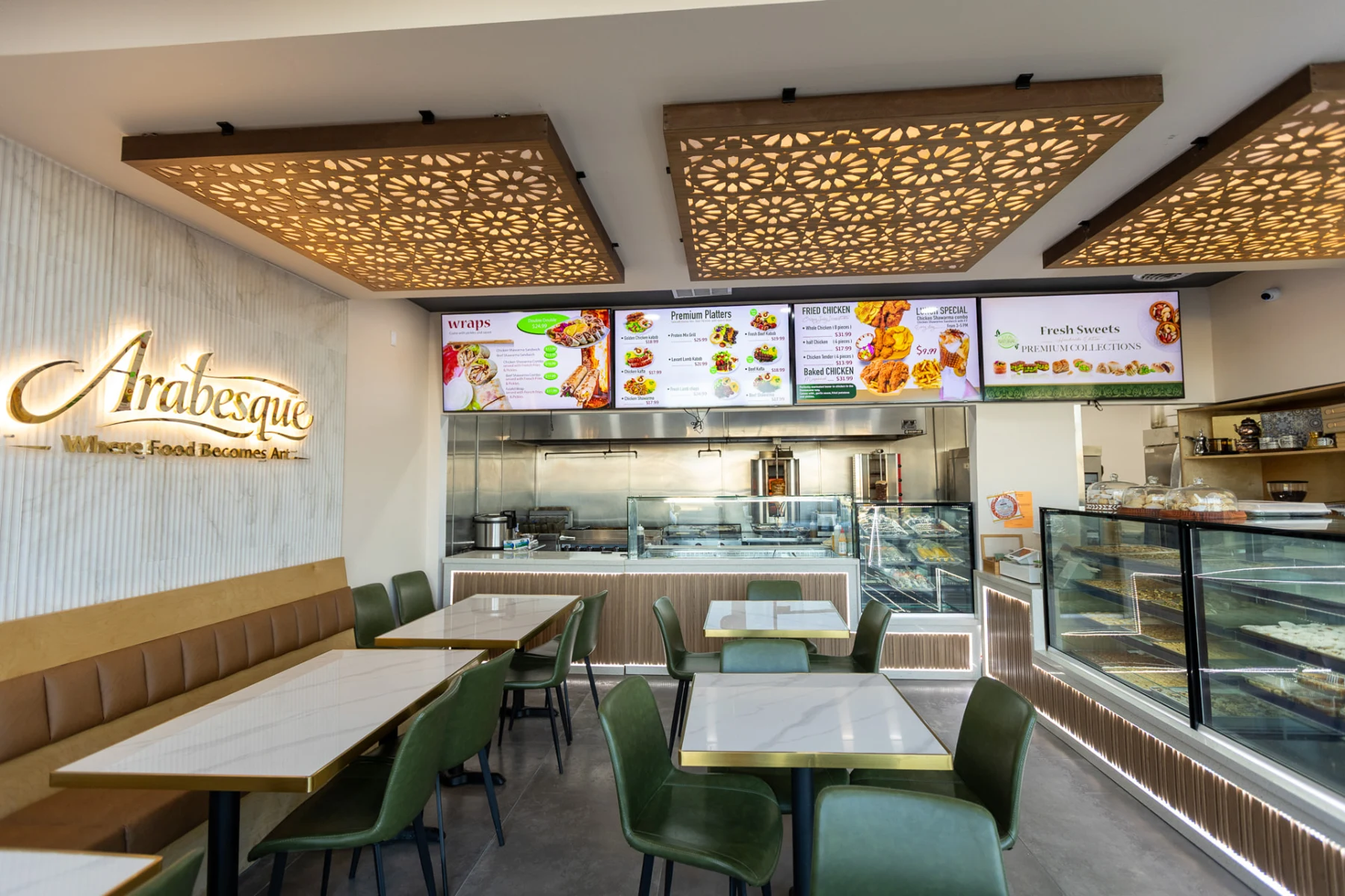 Arabesque restaurant dining area with olive seating, marble tables and illuminated patterned ceilings